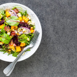 fresh-vegetable-salad-with-beetroot-arugula-red-onion-sorrel-chickpeas-pumpkin-grapes-white-plate-black-background-top-view (1)