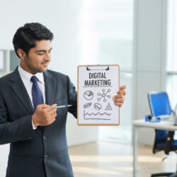 man-suit-standing-office-with-clipboard-pointing-poster-with-words (1)