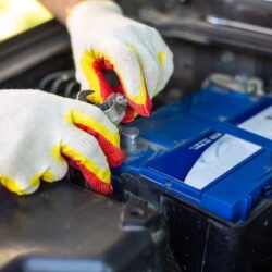 car-mechanic-unscrews-bolts-car-battery-accumulator-installation-replacement-repair_326821-963