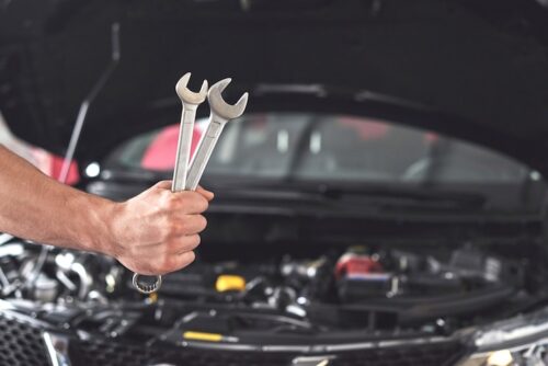 mechanic-holding-pair-wrenches-repair-garage_146671-19612 mechanic-holding-pair-wrenches-repair-garage_146671-19612