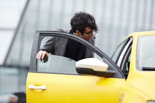 young-businessman-getting-taxi_1098-15507 young-businessman-getting-taxi_1098-15507