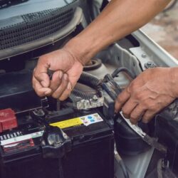 car-mechanic-working-install-battery-with-wrench-garage-repair-service_9635-740