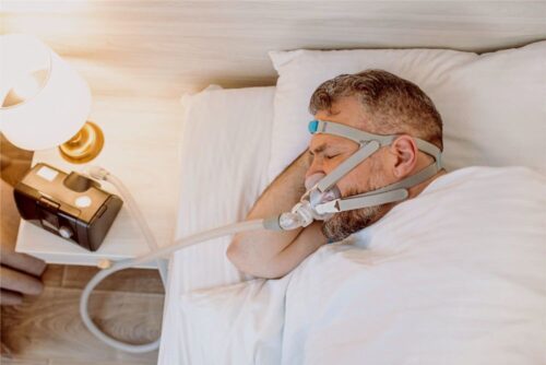 Sleep apnea patient sleeping with CPAP 140KB Sleep apnea patient sleeping with CPAP 140KB