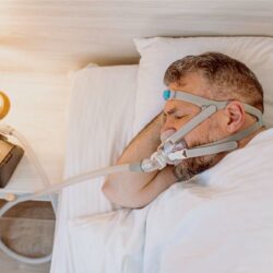 Sleep apnea patient sleeping with CPAP 140KB