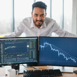 portrait-positive-successful-indian-arabian-trader-stock-market-broker-crypto-charts-laptop-screen_255667-46436