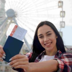 portrait-smiling-woman-showing-air-ticket-passport_11zon